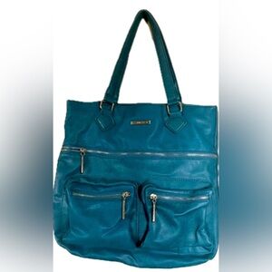 Stylish Rampage teal tote shoulder bag with mutilple zipper compartments.